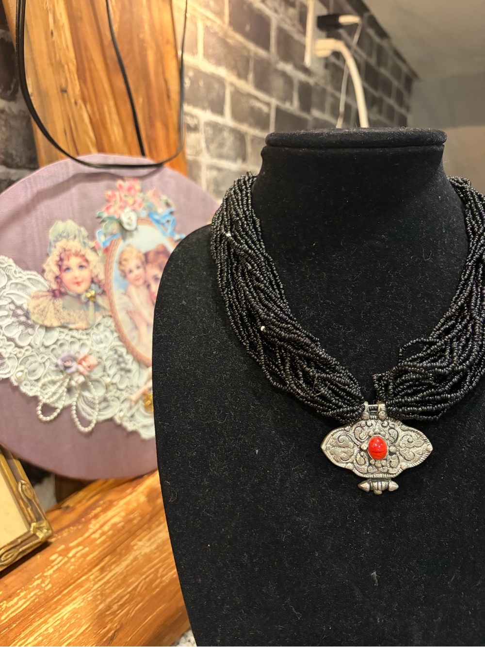 Black Beaded Multi-Strand Necklace with Silver Pendant and Red Stone